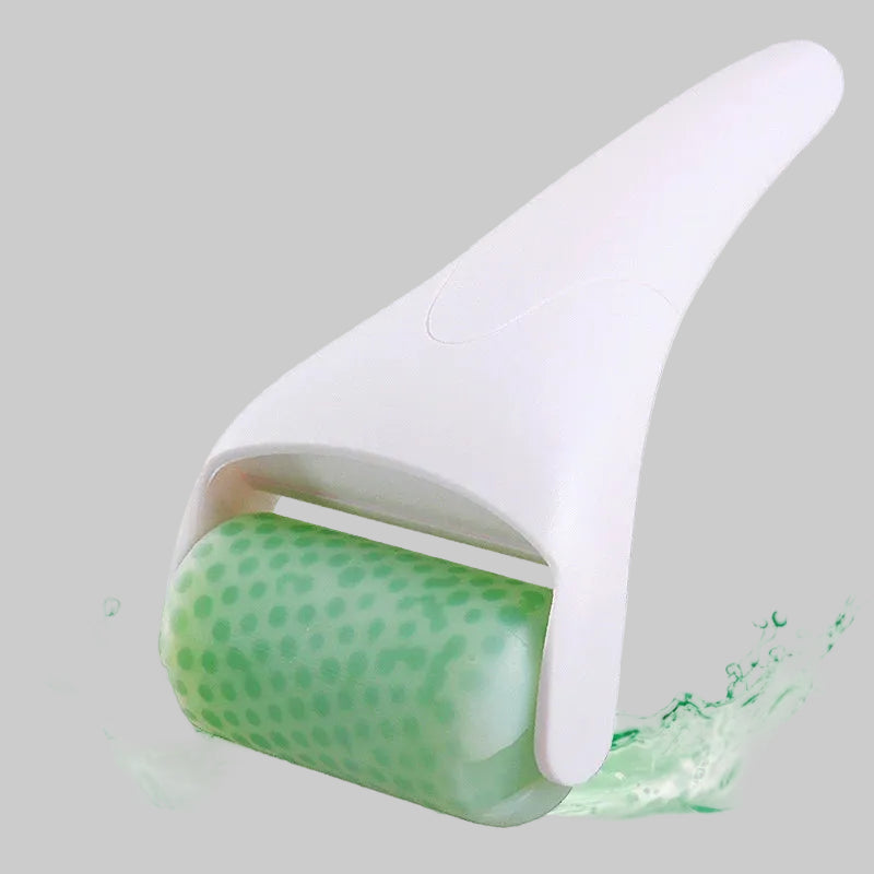 A white handheld facial roller tool with a green dotted silicone roller, shown with a water splash effect on a white background.